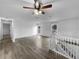 Spacious living room with luxury vinyl flooring, large windows, a staircase, and a ceiling fan at 10930 Albion Ct, Thornton, CO 80233