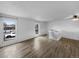 Bright living room with hardwood floors, neutral paint, and large windows at 10930 Albion Ct, Thornton, CO 80233