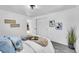 Bright bedroom featuring plush carpet, neutral tones, decorative wall art, and a glimpse of another room at 1173 Xenon St, Golden, CO 80401