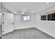 Bright carpeted bedroom with white walls, ceiling lights, and dual windows at 1173 Xenon St, Golden, CO 80401