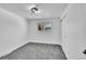 Minimalist bedroom with plush carpet, a single window providing natural light, and a modern ceiling light fixture at 1173 Xenon St, Golden, CO 80401