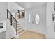 Beautiful entryway featuring wood and metal staircase and decorative front door with windows at 1173 Xenon St, Golden, CO 80401