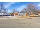 Inviting two-story home featuring blue siding, red shutters, and a well-maintained lawn for great curb appeal at 1173 Xenon St, Golden, CO 80401