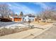 Charming two-story home with a well-manicured front yard, updated wooden garage door, and beautiful blue siding at 1173 Xenon St, Golden, CO 80401