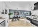 Open kitchen with dining area, featuring a unique accent wall and modern appliances, perfect for Gathering meals at 1173 Xenon St, Golden, CO 80401