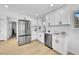 Well-lit kitchen featuring stainless steel appliances, white cabinets, and a tiled backsplash for a clean, modern look at 1173 Xenon St, Golden, CO 80401