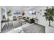 Carpeted living room with natural light from two windows and tasteful decor, including plants and comfortable seating at 1173 Xenon St, Golden, CO 80401