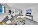 Carpeted living room featuring a gray sofa, natural light from a window, and tastefully decorated walls with artwork at 1173 Xenon St, Golden, CO 80401