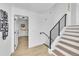 Modern staircase with black railings and wood steps leading to the lower level at 1173 Xenon St, Golden, CO 80401