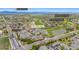 Aerial shot of townhomes near a golf course, lake, and local amenities with mountain views at 3751 W 136Th Ave # L1, Broomfield, CO 80023