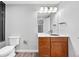 Contemporary bathroom with wood cabinets, marble countertops, and walk-in shower at 3751 W 136Th Ave # L1, Broomfield, CO 80023