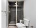 Modern bathroom with gray tiled shower, glass door, and matching gray vanity at 3751 W 136Th Ave # L1, Broomfield, CO 80023