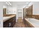 A primary bathroom featuring double sinks, tiled floors, a bathtub and a standup shower at 3751 W 136Th Ave # L1, Broomfield, CO 80023