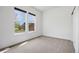Bright bedroom with plush carpet, two large windows, and a closet ready for personalization at 3751 W 136Th Ave # L1, Broomfield, CO 80023