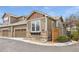 Attractive townhome featuring stone accents, tan siding, and an attached garage in a residential neighborhood at 3751 W 136Th Ave # L1, Broomfield, CO 80023