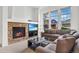 Bright living room with a stone fireplace, large windows, and comfortable seating at 3751 W 136Th Ave # L1, Broomfield, CO 80023