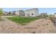 Large backyard featuring a grass area, rock, and fencing at 42853 Ivydel St, Elizabeth, CO 80107