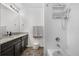 Well-lit bathroom with a double vanity, granite countertop, and a shower with storage racks at 42853 Ivydel St, Elizabeth, CO 80107
