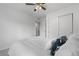 Bright bedroom featuring a ceiling fan, white walls, and a closet with sliding doors at 42853 Ivydel St, Elizabeth, CO 80107