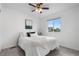 Bright bedroom with a large window, ceiling fan, and stylish neutral decor at 42853 Ivydel St, Elizabeth, CO 80107