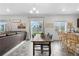 Open-concept dining area with dark wood table and chairs, seamlessly connecting the living room and kitchen at 42853 Ivydel St, Elizabeth, CO 80107