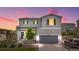 Charming two-story home with a gray exterior, well-manicured lawn, and attached two-car garage at 42853 Ivydel St, Elizabeth, CO 80107