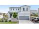 Charming two-story home with a gray exterior, well-manicured lawn, and attached two-car garage at 42853 Ivydel St, Elizabeth, CO 80107