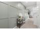 Hallway with decorative accent wall, console table and access to a staircase at 42853 Ivydel St, Elizabeth, CO 80107