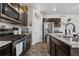 Functional kitchen with granite countertops, stainless steel appliances and tile flooring at 42853 Ivydel St, Elizabeth, CO 80107