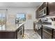 Modern kitchen with granite countertops, stainless steel appliances, dark cabinets and breakfast nook at 42853 Ivydel St, Elizabeth, CO 80107