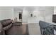 Open living area featuring neutral colors and a cozy leather sofa and workspace at 42853 Ivydel St, Elizabeth, CO 80107
