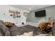 Comfortable living room with a large sectional and modern accent wall at 42853 Ivydel St, Elizabeth, CO 80107