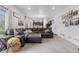 Spacious living room featuring a plush leather sofa and an open layout that flows into the kitchen at 42853 Ivydel St, Elizabeth, CO 80107