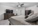 Comfortable bedroom with a ceiling fan, wooden furniture, and a plush striped bed at 42853 Ivydel St, Elizabeth, CO 80107