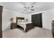 Well-lit bedroom featuring a ceiling fan, stylish furniture, and soft carpeted floors at 42853 Ivydel St, Elizabeth, CO 80107