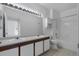 Bright bathroom with double sinks, large mirror with vanity lighting, and a shower-tub combo at 6017 Castlegate Dr # F15, Castle Rock, CO 80108