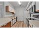 The kitchen features wood grain floors, white cabinets, and modern appliances at 6017 Castlegate Dr # F15, Castle Rock, CO 80108