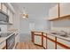Bright kitchen features white and brown cabinets and a breakfast bar open to the living area at 6017 Castlegate Dr # F15, Castle Rock, CO 80108