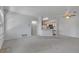 Spacious living room with kitchen view, bright lighting, and neutral walls at 6017 Castlegate Dr # F15, Castle Rock, CO 80108