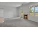 Cozy living room with fireplace, balcony, and a large window that floods the room with light at 6017 Castlegate Dr # F15, Castle Rock, CO 80108