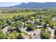 Stunning aerial view of a neighborhood with lush trees, green lawns, and mountain views in the background at 2901 Lorraine Ct, Boulder, CO 80304