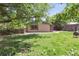 Lush backyard featuring a brick home, storage shed, and wooden fence providing a private outdoor space at 2901 Lorraine Ct, Boulder, CO 80304