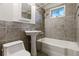 Well-lit bathroom with tub, tiled walls, and pedestal sink at 2901 Lorraine Ct, Boulder, CO 80304