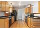Bright kitchen featuring wood cabinets, black appliances and tile flooring at 2901 Lorraine Ct, Boulder, CO 80304