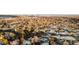 Aerial view of a golf course and surrounding neighborhood with a distant city skyline at 7177 W 8Th Ave, Lakewood, CO 80214