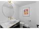 Stylish powder room with marble vanity and gold fixtures at 7177 W 8Th Ave, Lakewood, CO 80214