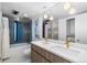 Modern bathroom with double vanity, tiled shower, and bathtub at 7177 W 8Th Ave, Lakewood, CO 80214