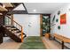 Bright and airy entryway with wooden bench and stairs at 7177 W 8Th Ave, Lakewood, CO 80214