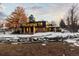 Modern home exterior with large windows and a unique design, nestled beside a waterway at 7177 W 8Th Ave, Lakewood, CO 80214