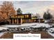 A modern two-story home with large windows and a well-kept landscape covered with snow at 7177 W 8Th Ave, Lakewood, CO 80214